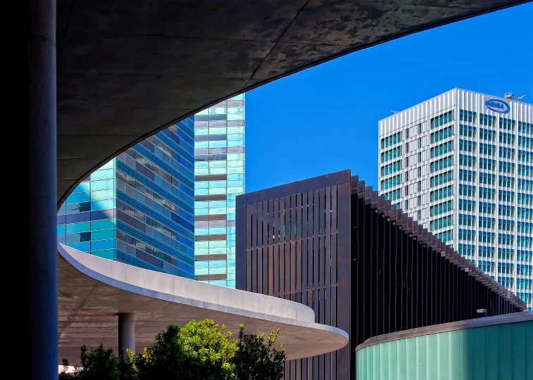 buildings stand behind an arch near a large sidewalk