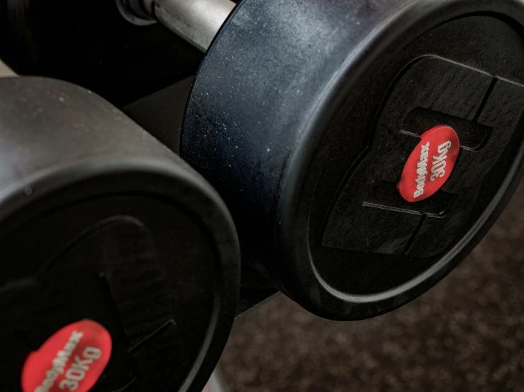 two black and red gym dumbs next to each other