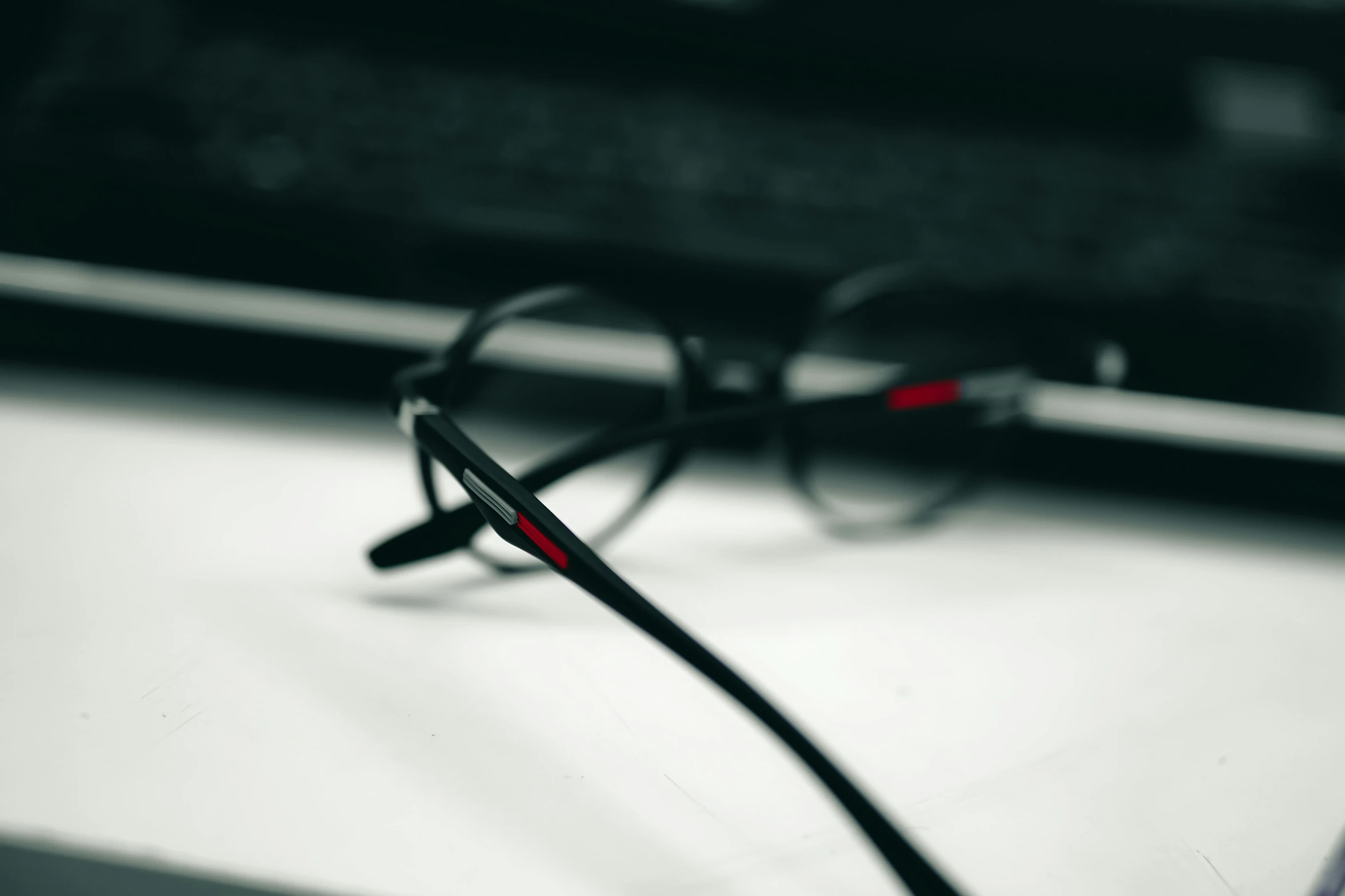 a pair of black glasses on a table