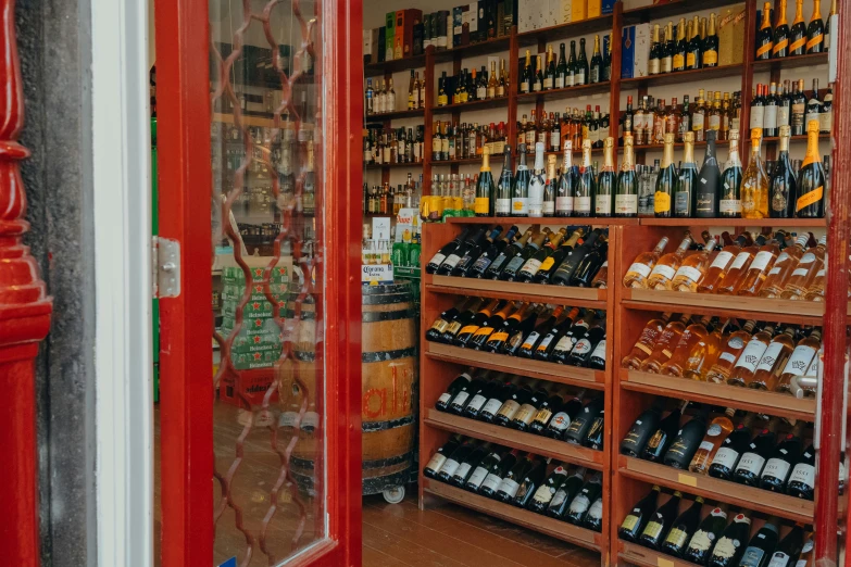 a wall filled with many bottles and wine glasses