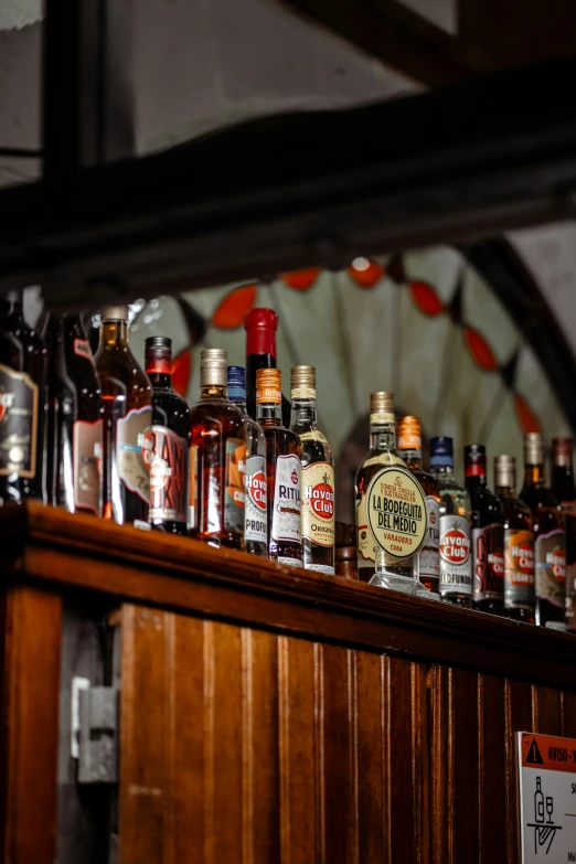 this is a row of liquor bottles on a bar