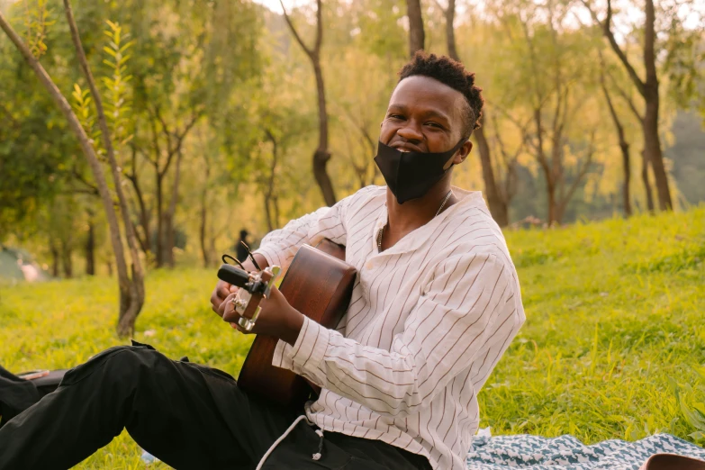 a man in a white shirt is holding a guitar