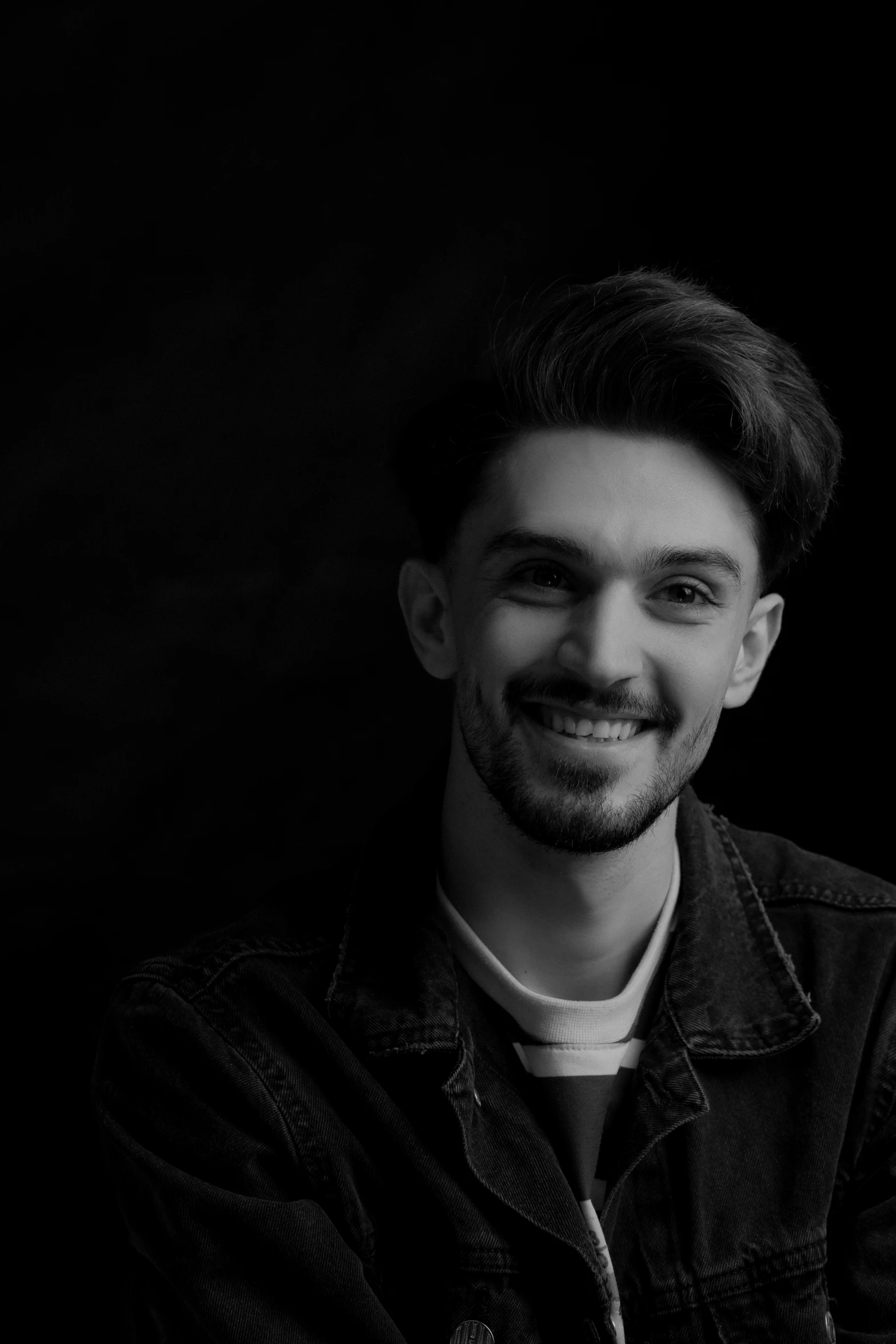 a black and white po of a young man smiling