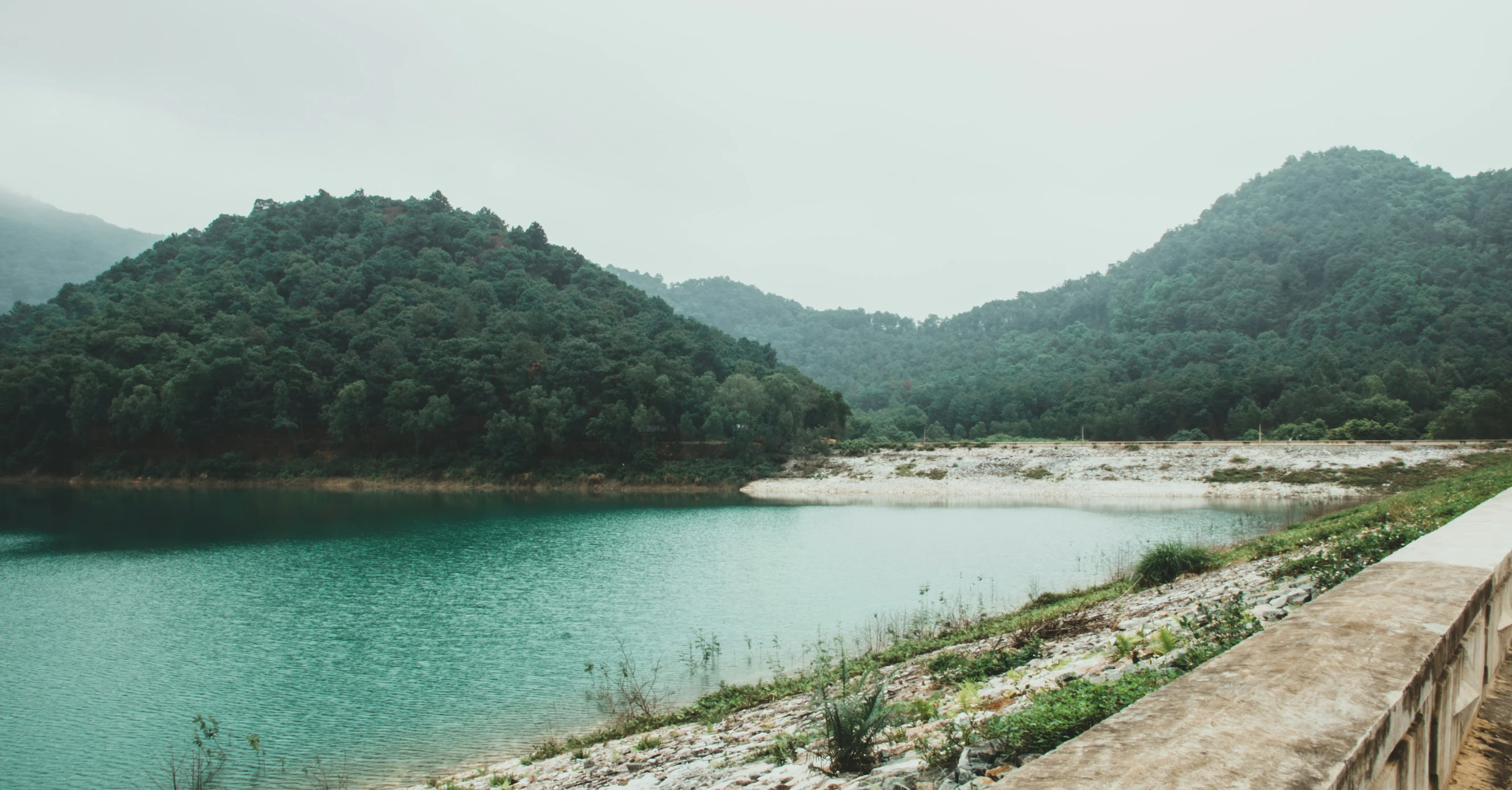 a body of water sitting between two hills