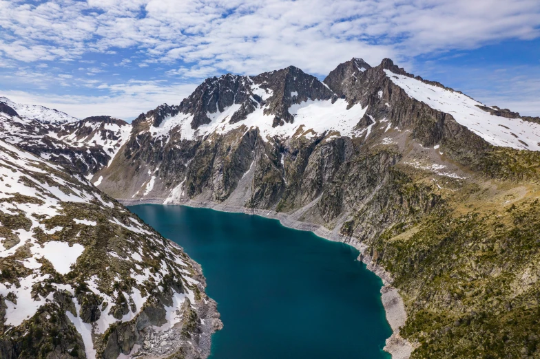 a large body of water sitting below a snow covered mountain