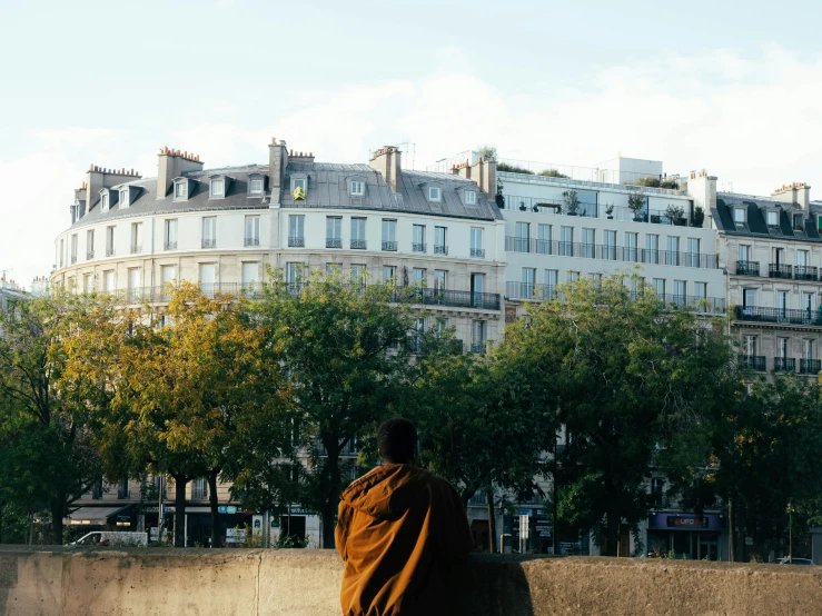 the building is near a man in an orange jacket