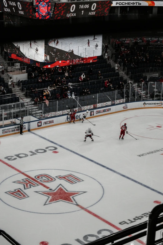 two teams playing hockey on a snowy ice rink