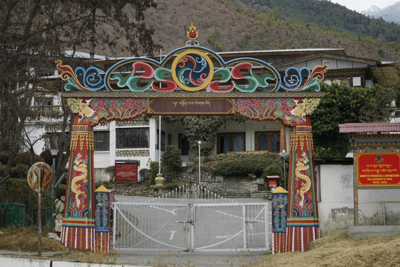 colorful gazebo with two statues and a fountain in front