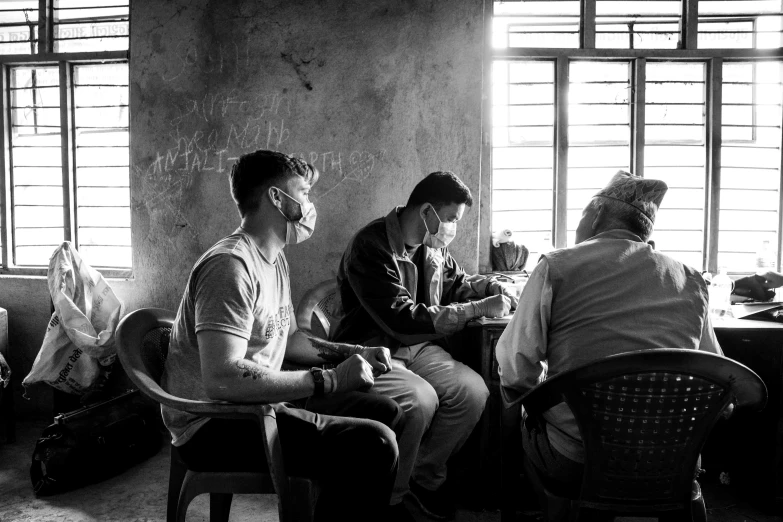 people sitting and standing inside of a building