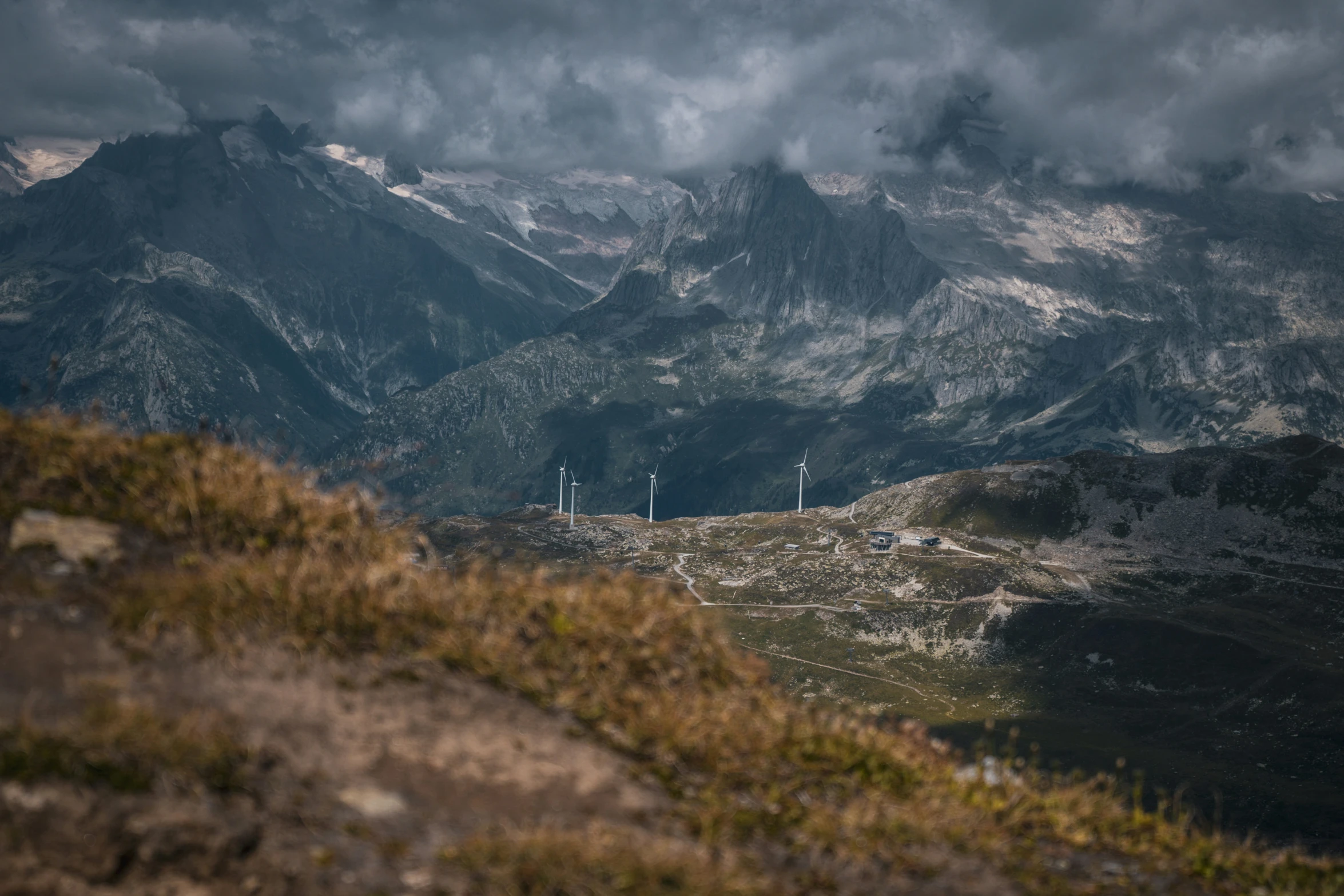 a view from top of a hill at a wind farm