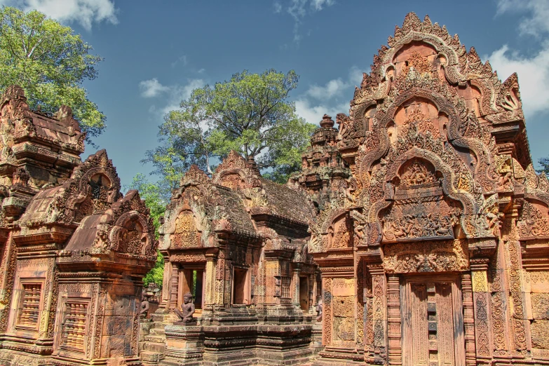 a temple with two tiered towers, surrounded by brick pillars and pillars