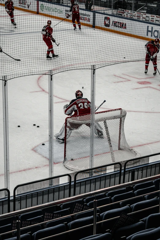 a hockey goalie is seen through the net