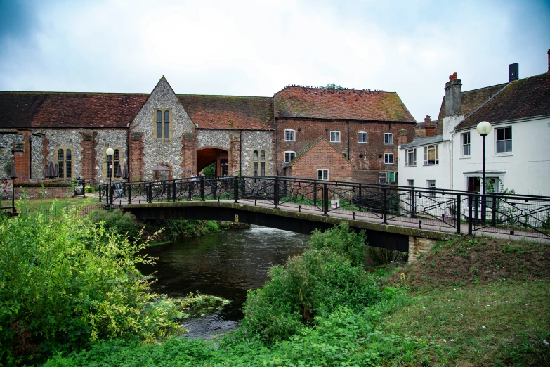 a building that has a bridge over a pond