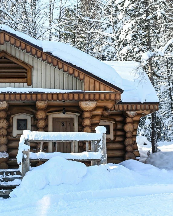 a log cabin with snow piled on top