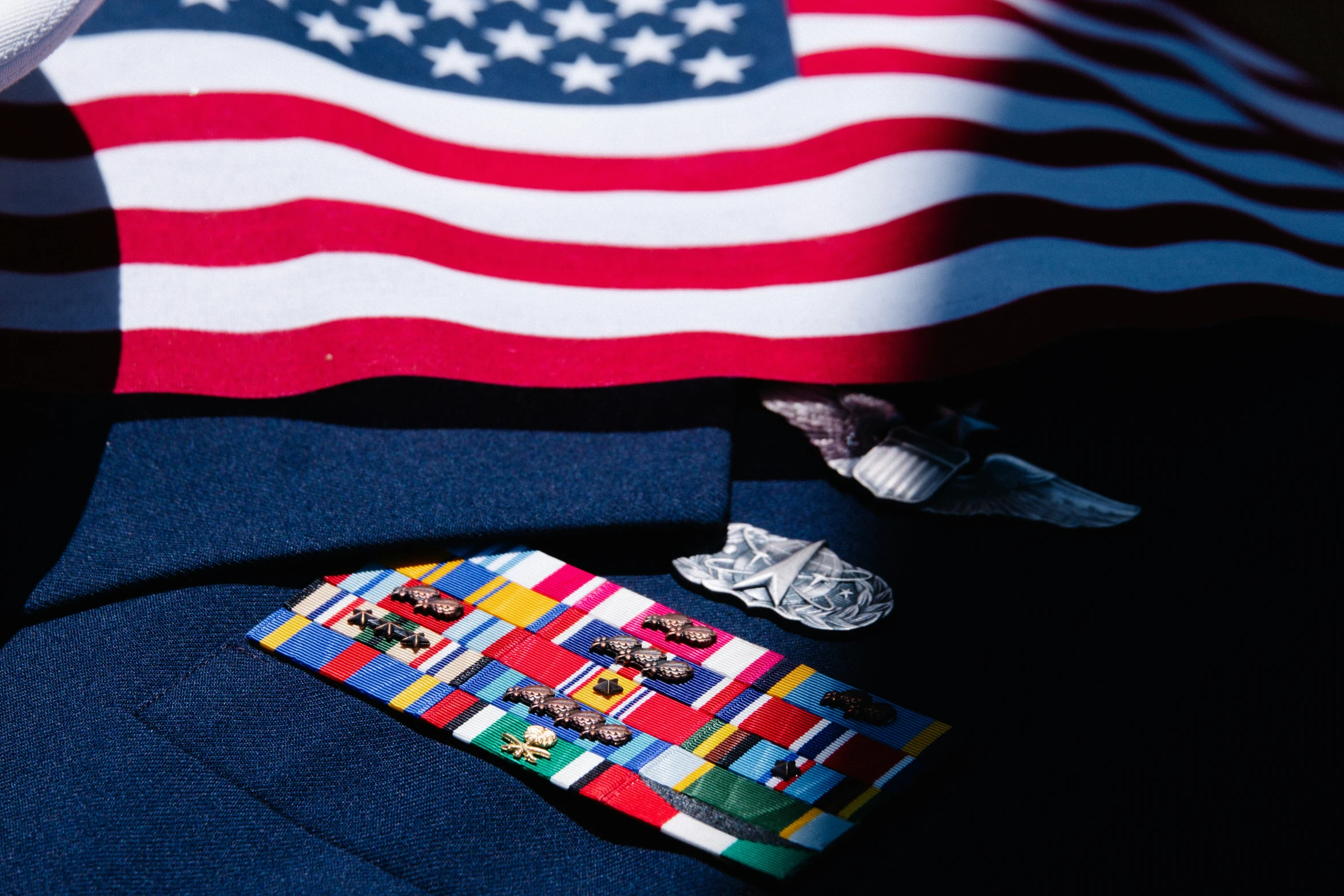 a tie on top of some pins in front of a flag