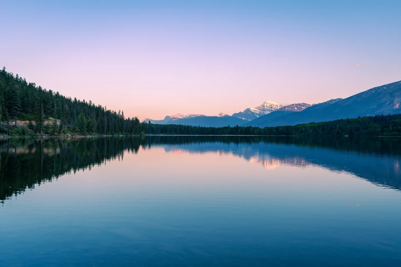 an empty river near some mountains at sunset