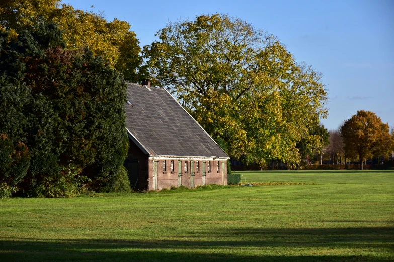 an old house with a roof in a field