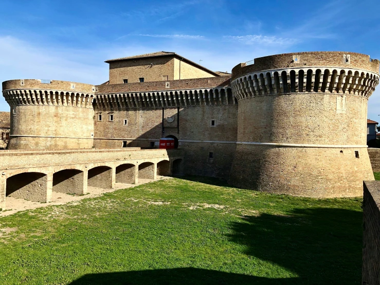 an old castle like structure with grass around it