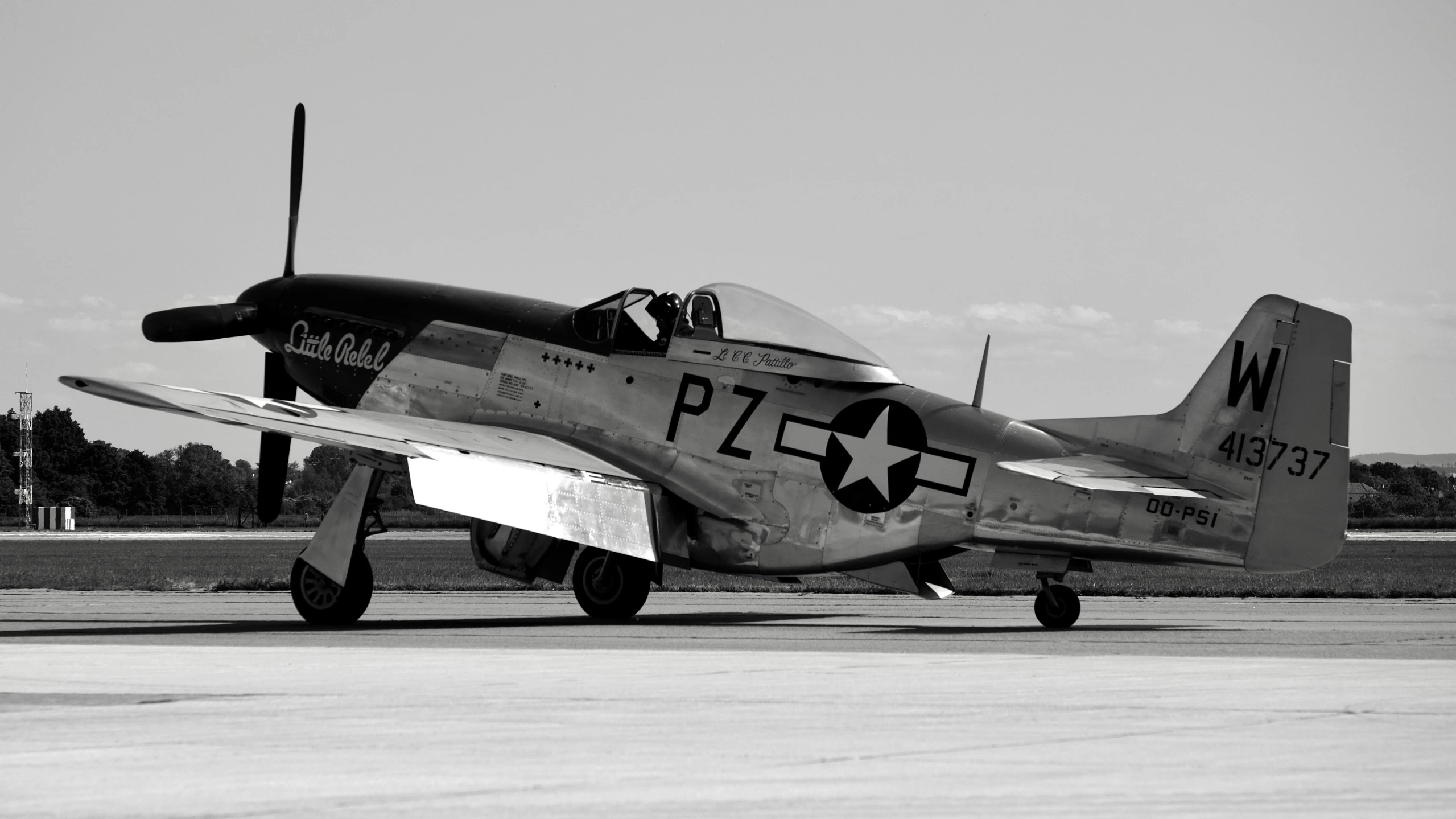 a fighter jet sits on a runway with no wheels