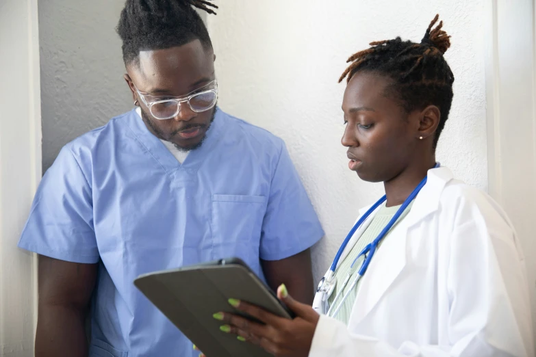 a woman standing next to a man in white coat