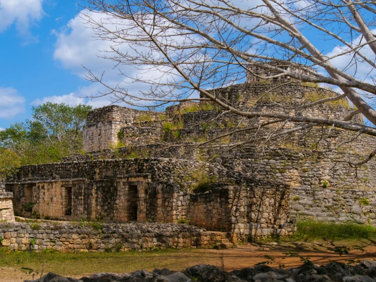 a stone structure surrounded by trees and rocks