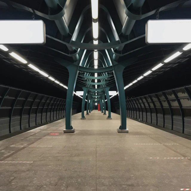 several long pillars in the middle of an empty building