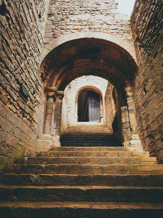 an entrance to a building with stairs and arches