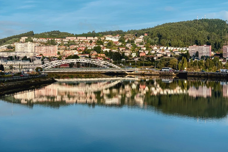 an image of a river view with buildings on the hill in background