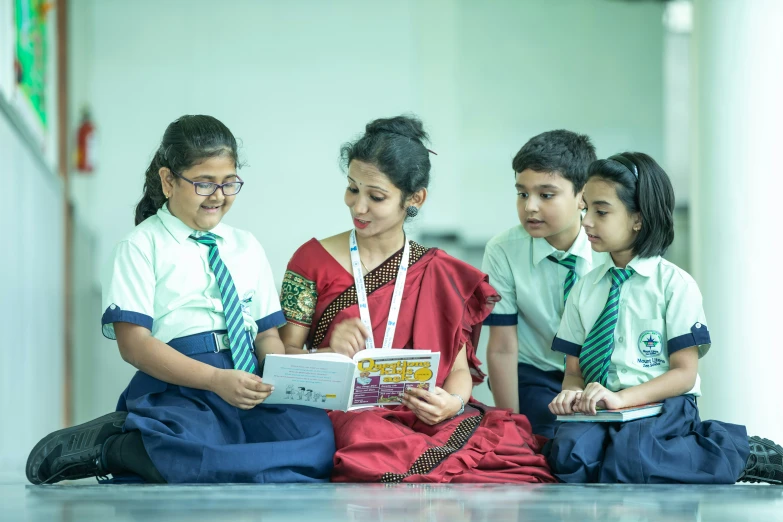 three s are reading a magazine together