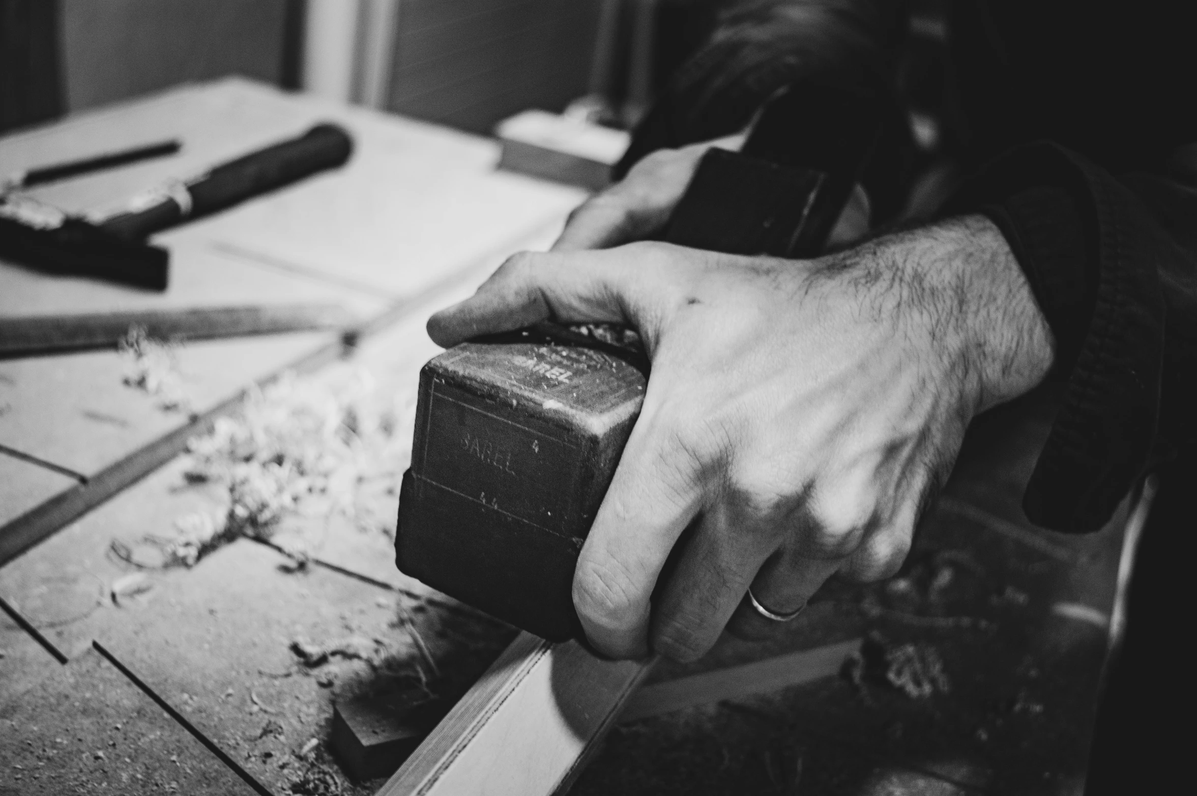 a person with their hands on a block of wood