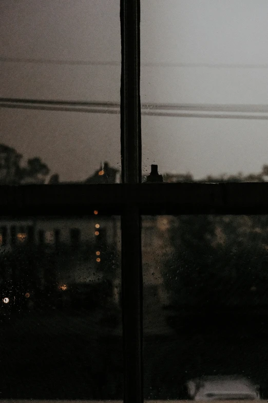 view of a street from a window with rain outside