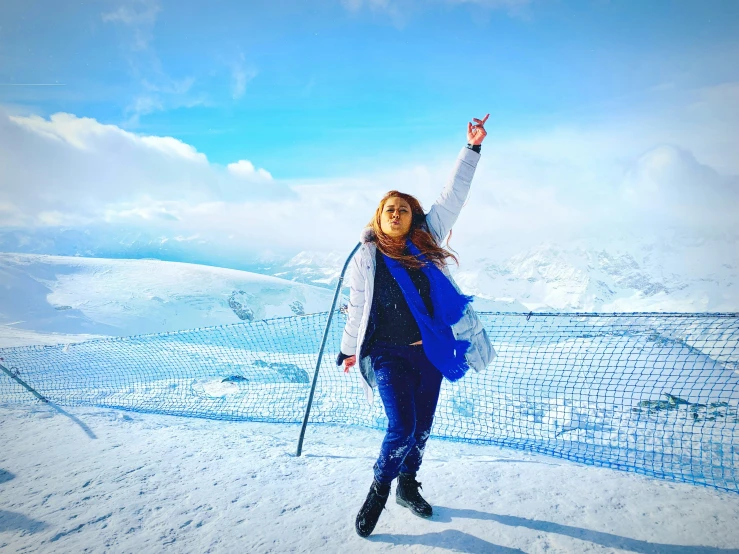 a woman holding up a snow phone while posing for a picture