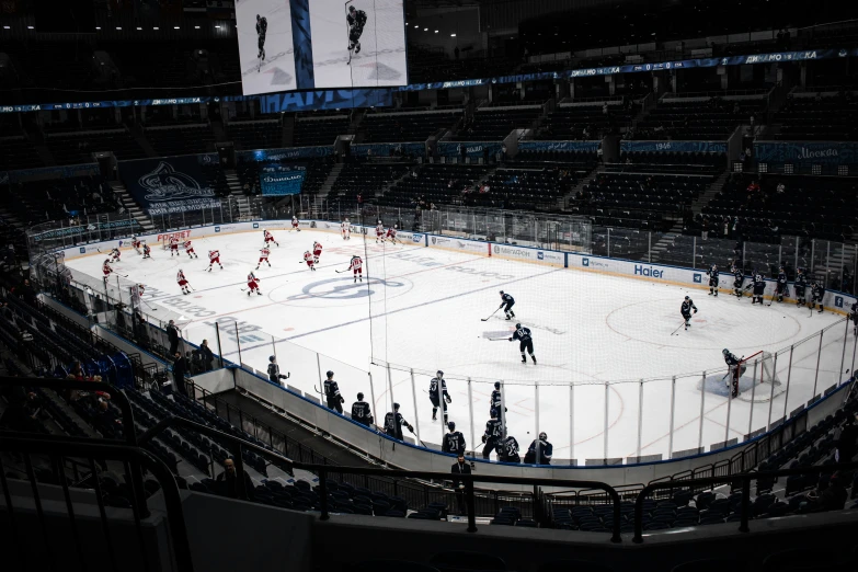 an ice hockey arena with people playing