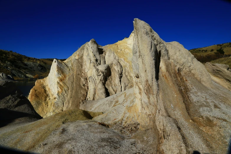 the mountains with large rocks under them have snow