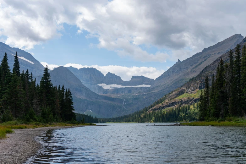 a mountain range sits above the calm water