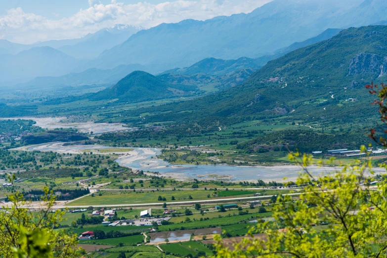 the mountains are green as the water is flowing down them