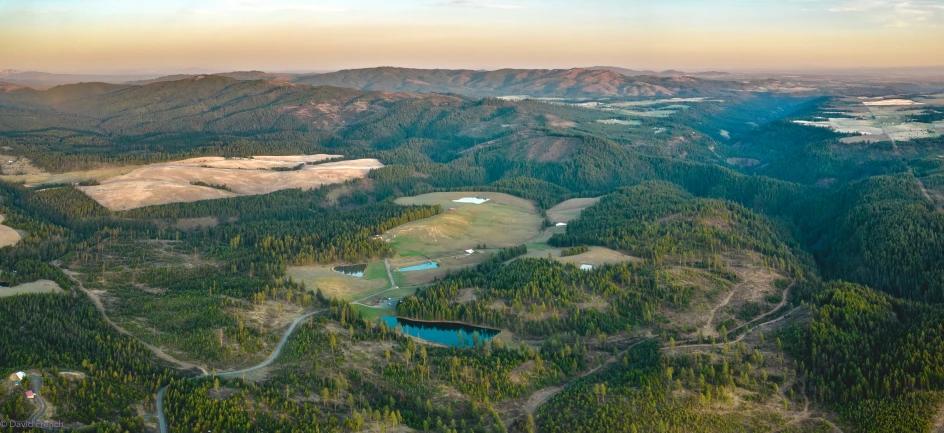 an aerial view of a forested area of mountains