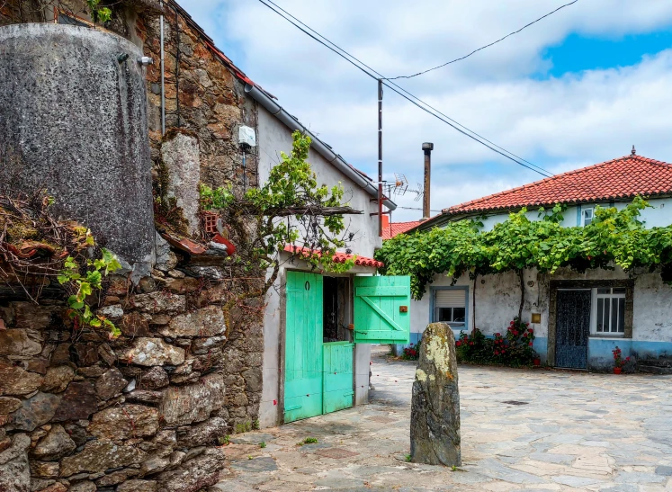 the corner of a street with a stone building