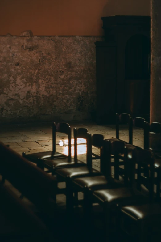 an empty room with a row of chairs sitting near the floor