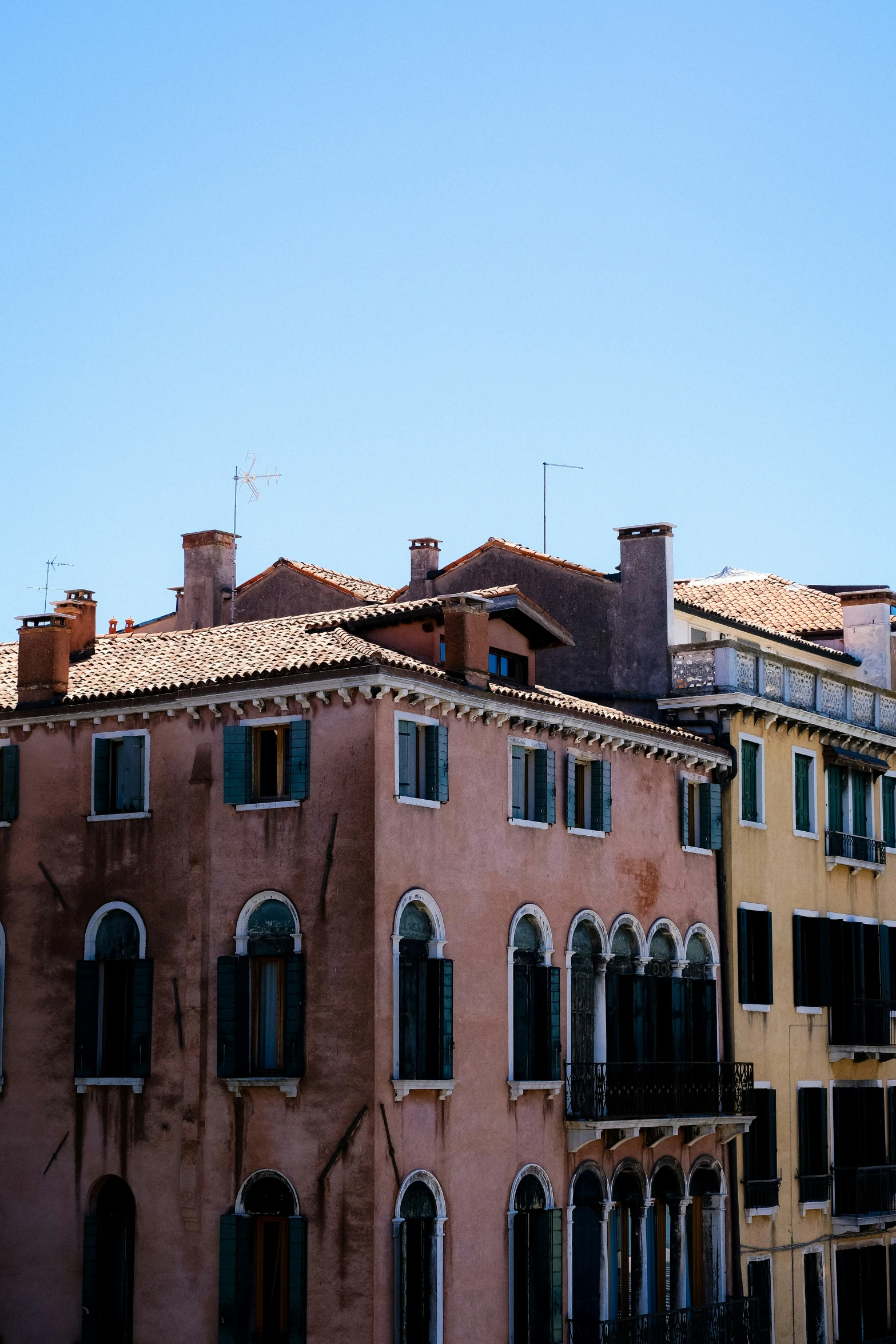 a row of different colored buildings with windows