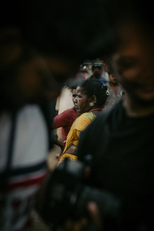 many people are sitting on the floor with cameras in their hands