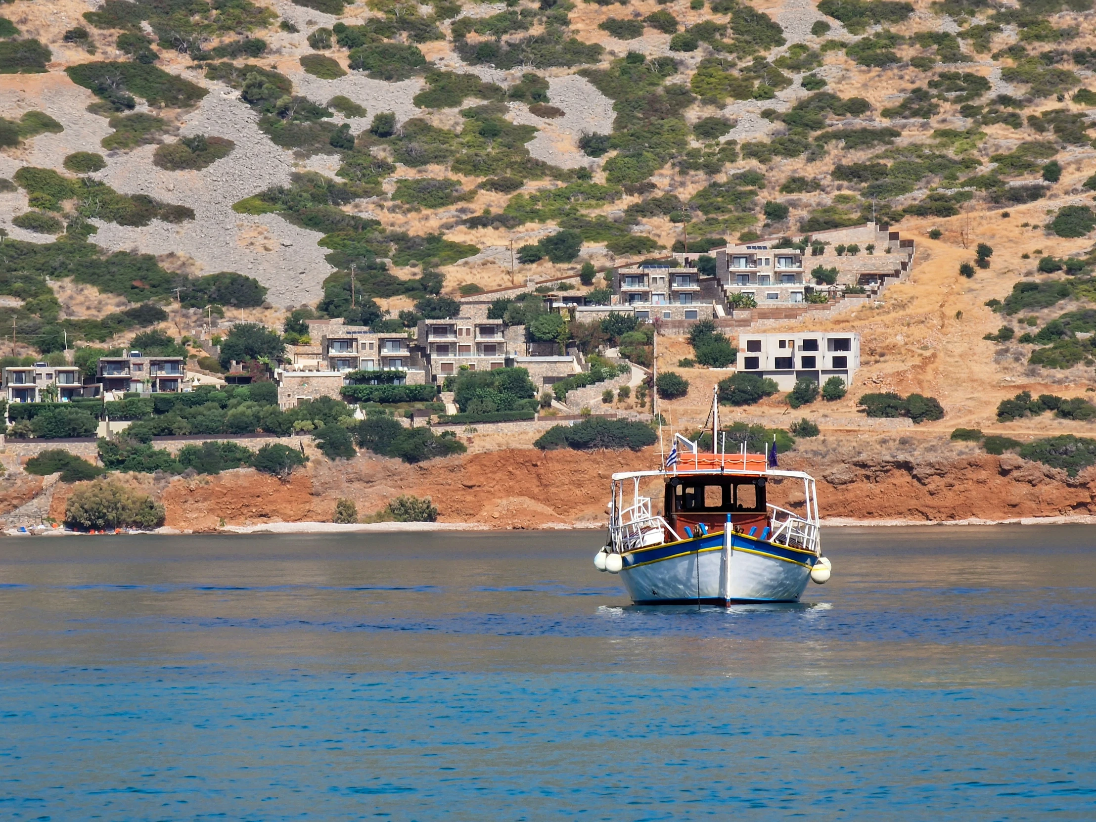 a large boat in a lake by houses