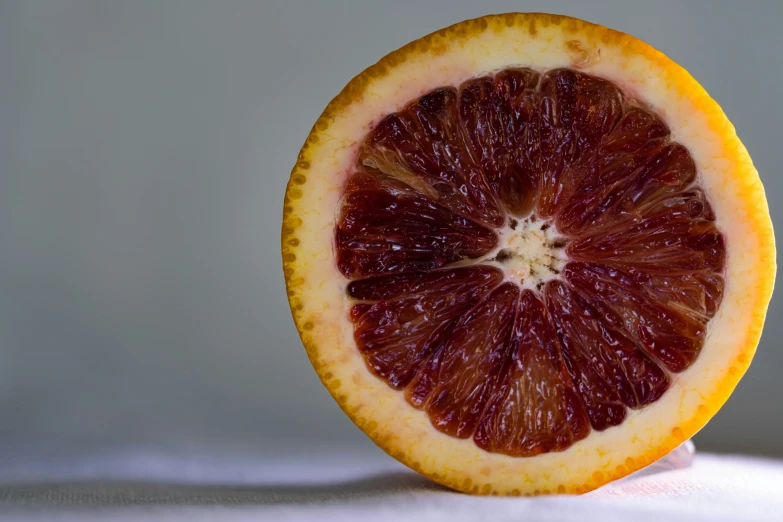 half of a  orange sitting on top of a white surface