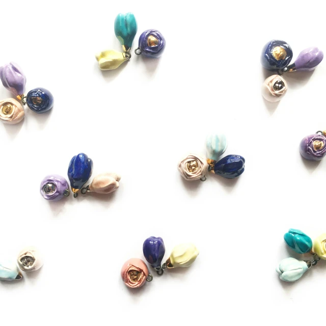 many different colored beads on white surface