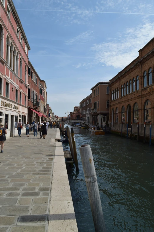 people walking in a canal on a sunny day