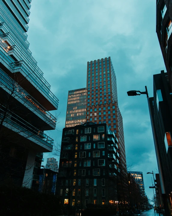 some tall buildings in a city and sky