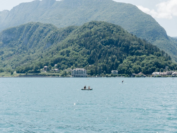 small boats in the water near a mountain range