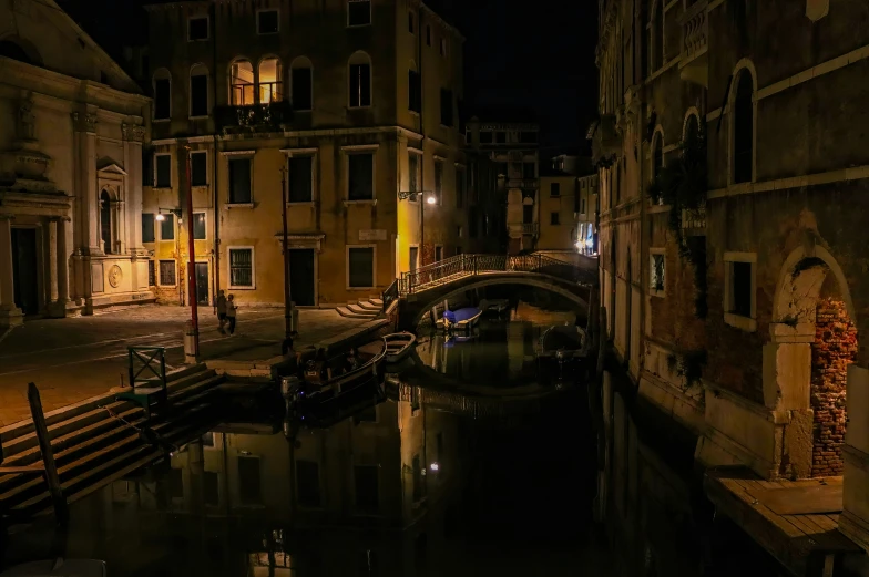 a canal on a river in a city at night