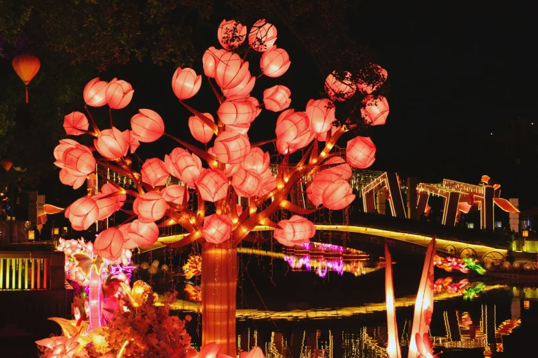 a colorful display of lanterns and flowers at night