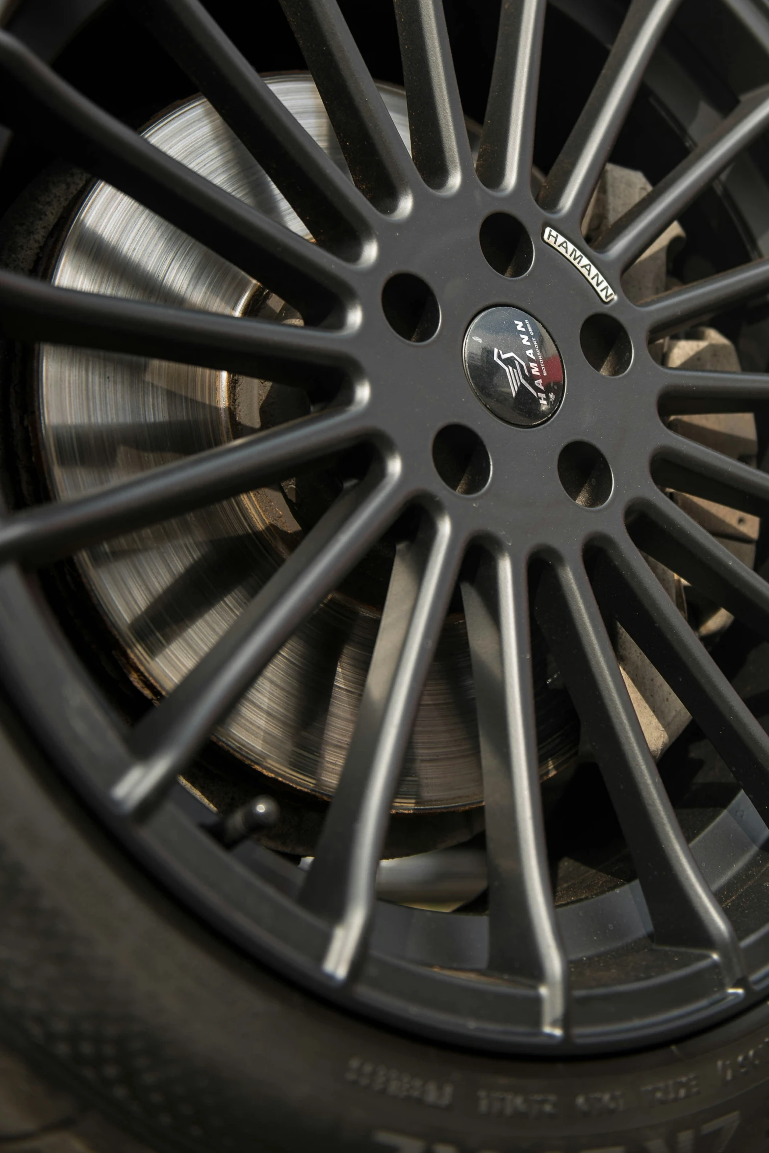 closeup of a tire wheel with the spokes and rim